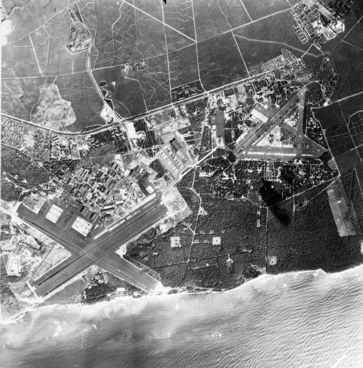 The Ewa Plain on the south coast of Oahu, Hawaii with Barbers Point Naval Air Station on the left and the former Ewa Marine Corps Air Station on the right, Nov 20, 1959