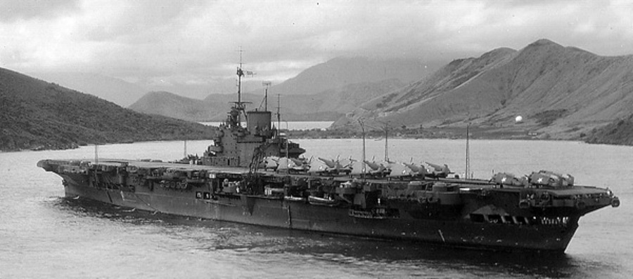 HMS Victorious at anchor in the Solomons, Jul 1943. This was during the period Victorious was on loan to the US Fleet. Note US F4F Wildcats and TBM Avengers on the flight deck.