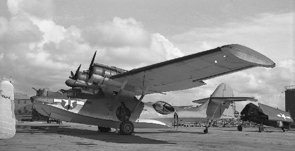 PBY-5A Catalina and F6F Hellcat on the pad at Naval Air Station Alameda, California, United States, 1947. Note that the Hellcat’s engine has been removed.
