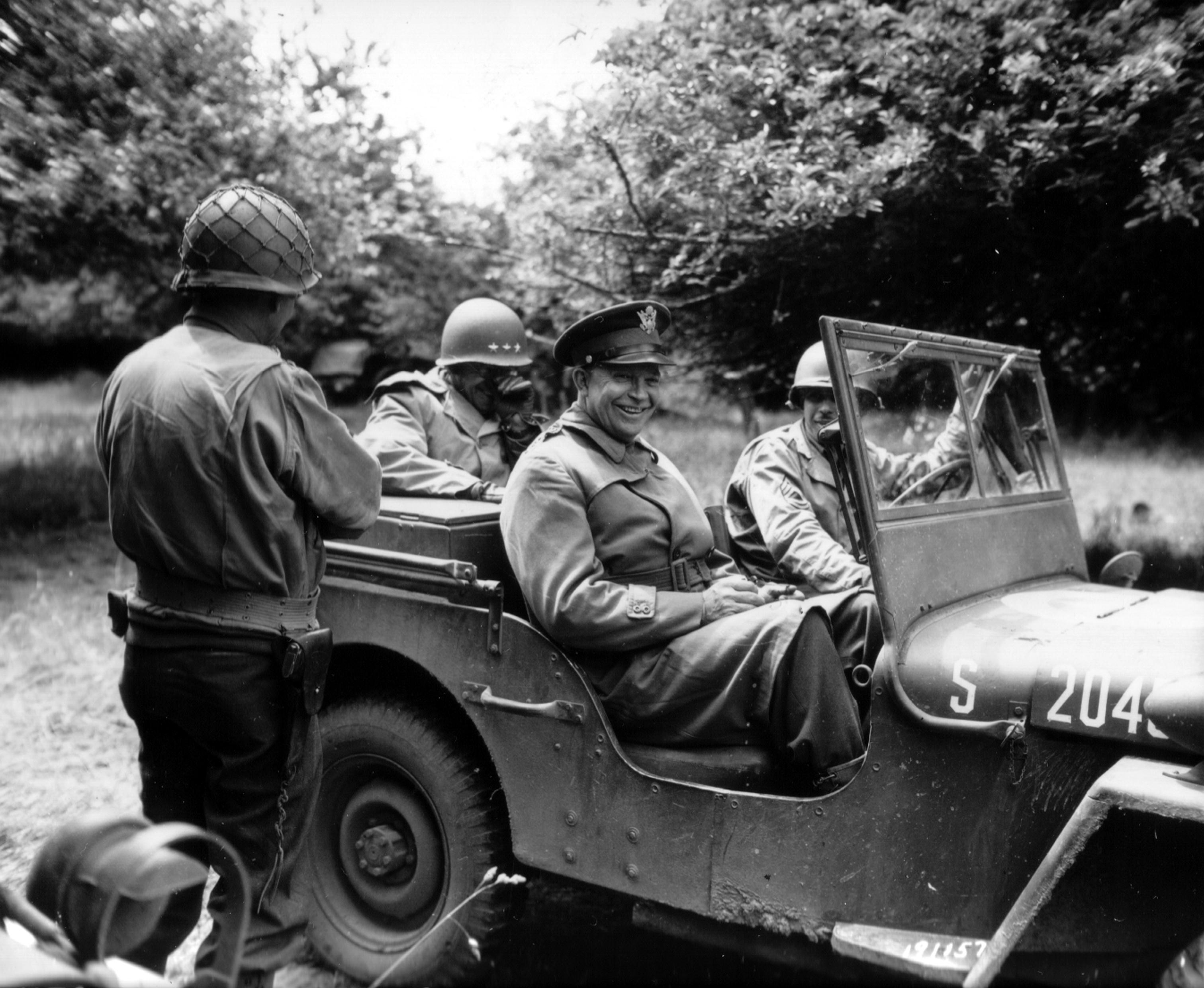 Generals Dwight Eisenhower and Omar Bradley share a laugh as they leave Gen Ira Wyche’s 79th Division headquarters in Huanville, Normandy, France, July 4, 1944.