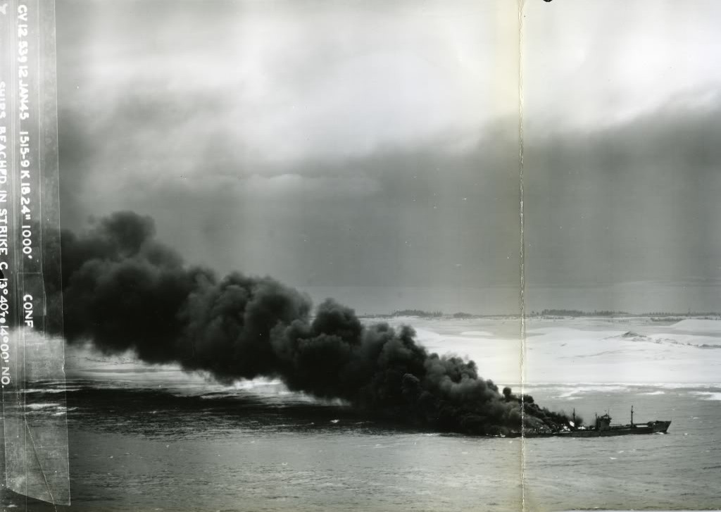 Japanese Type 2AT tanker Otsusan Maru burning and heading for the beach on the coast of French Indochina (Vietnam) north of Qui Nhon after its convoy was attacked by 175 United States Navy carrier planes, Jan 12, 1945.