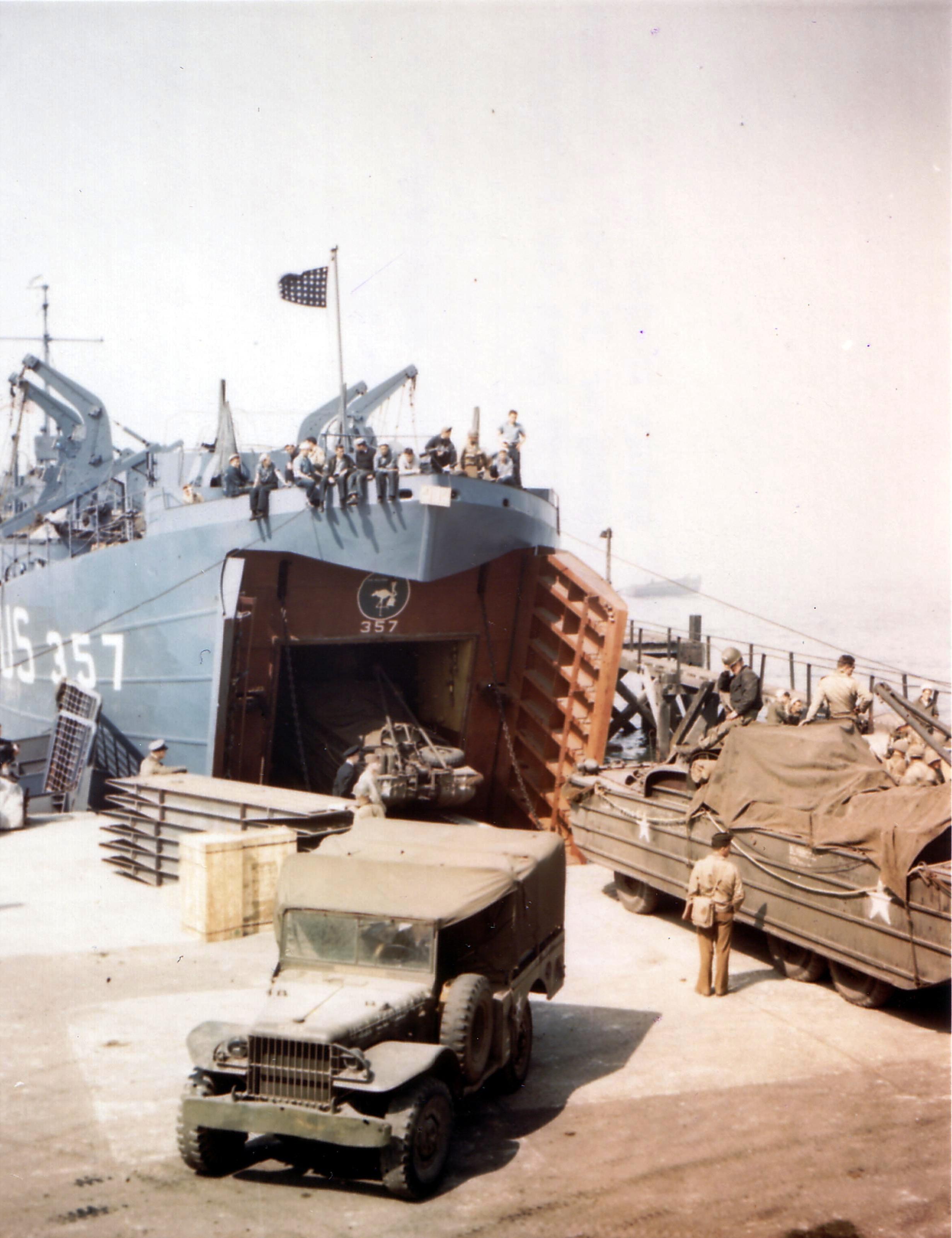LST-357 at a port in southern England being loaded with DUKWs in preparation for the D-Day Normandy invasion, early June 1944.
