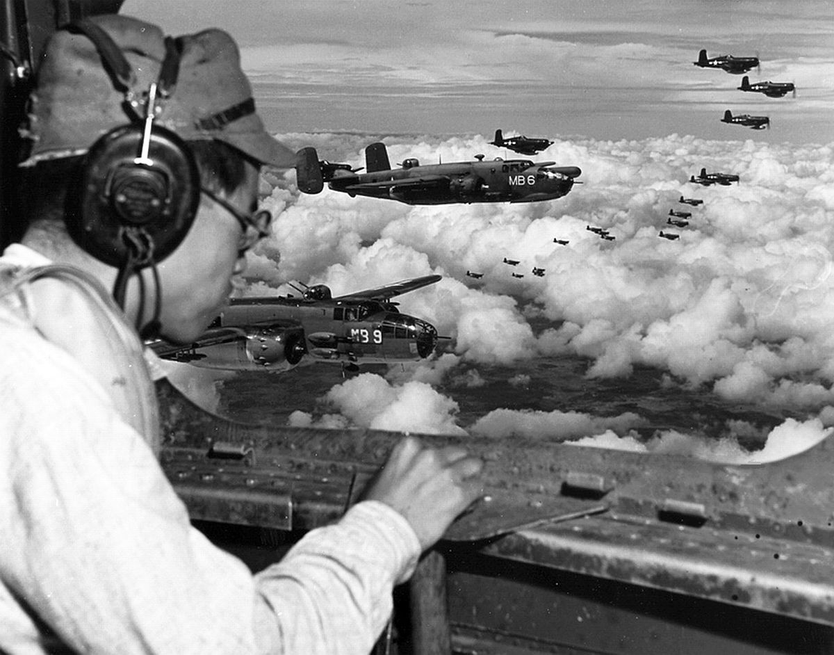 From the radio operator’s position in a USMC PBJ Mitchell, Japanese POW 2Lt Minoru Wada looks for landmarks to find the Japanese 100th Infantry Division headquarters complex, Aug 9, 1945, Mindanao, Philippines