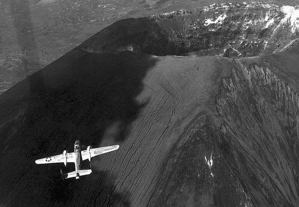 USAAF B-25 Mitchell bomber flying over the crater of Mt Vesuvius, Italy, May 1945.