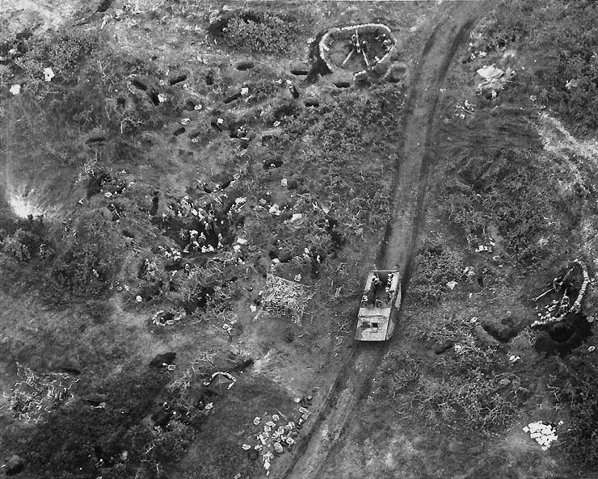 Overhead view of US Marine LVT passing artillery positions on Iwo Jima, Feb 20, 1945