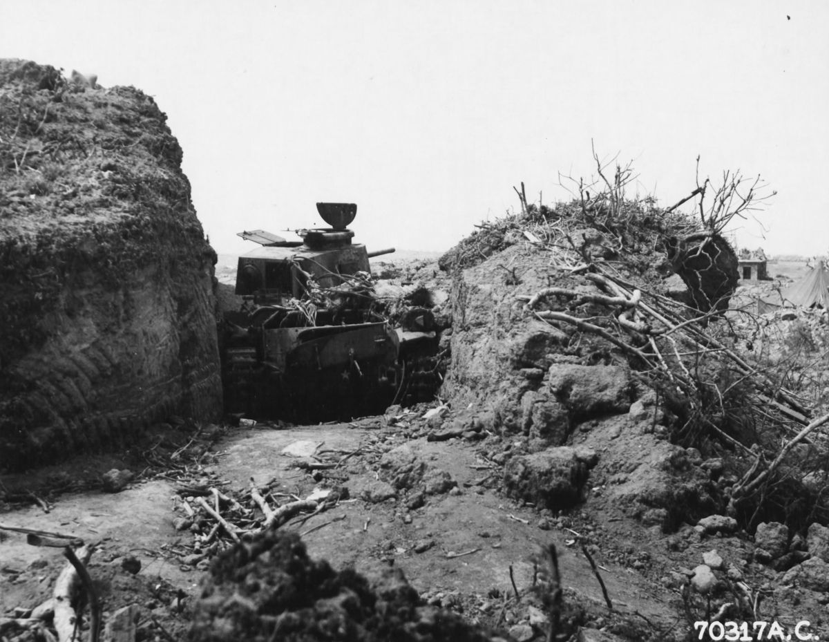 A Japanese tank wedged between banks of solid earth was very difficult for US Marines to see or attack from the front, Iwo Jima, Mar 25, 1945.