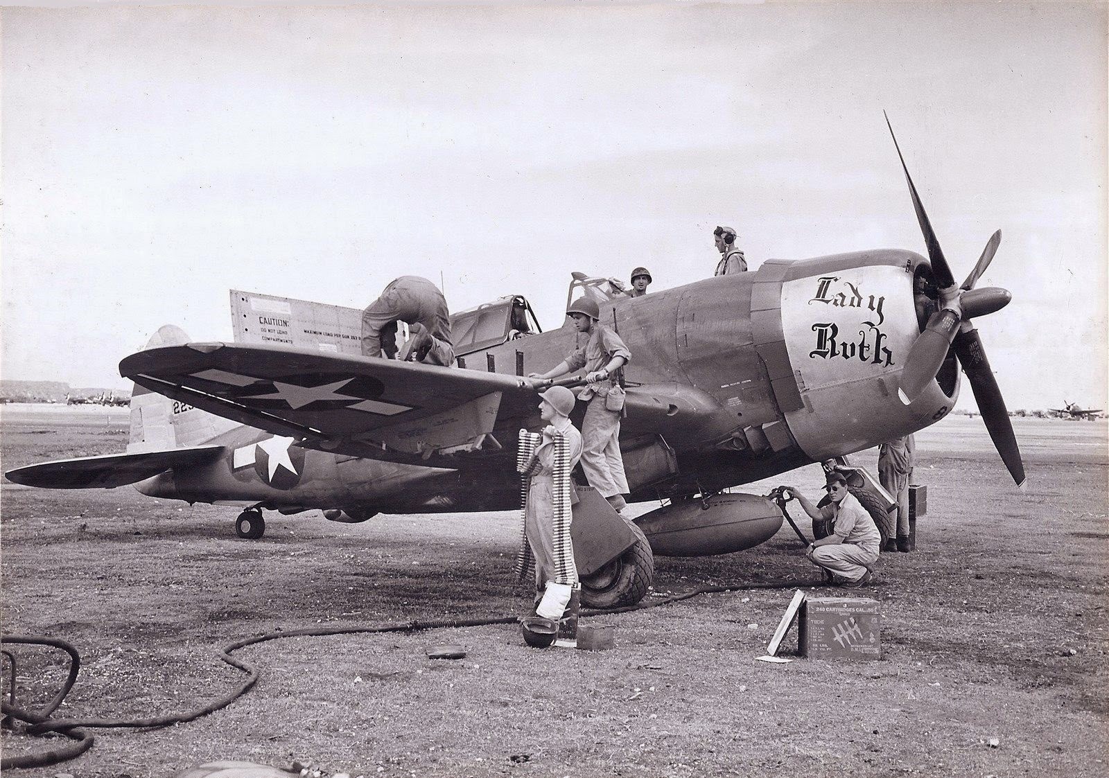 A staged photograph of ground crews performing their collective duties to service P-47D Thunderbolt ‘Lady Ruth’ of the 318th Fighter Group at East Field, Saipan, Mariana Islands, Jun 1944-Apr 1945