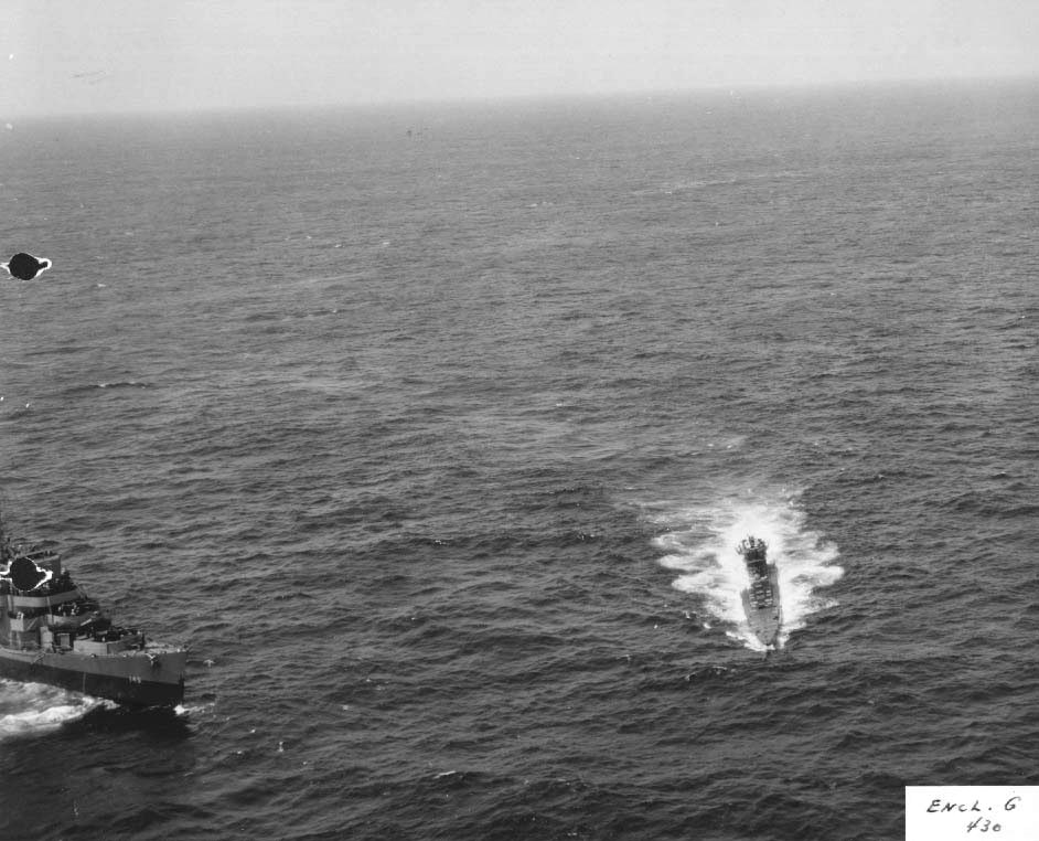 Abandoned by her crew but with engines still running, German U-505 circles at 7 knots as US boarding parties complete the capture and escort USS Chatelain stands by off the West African coast, 4 Jun 1944.