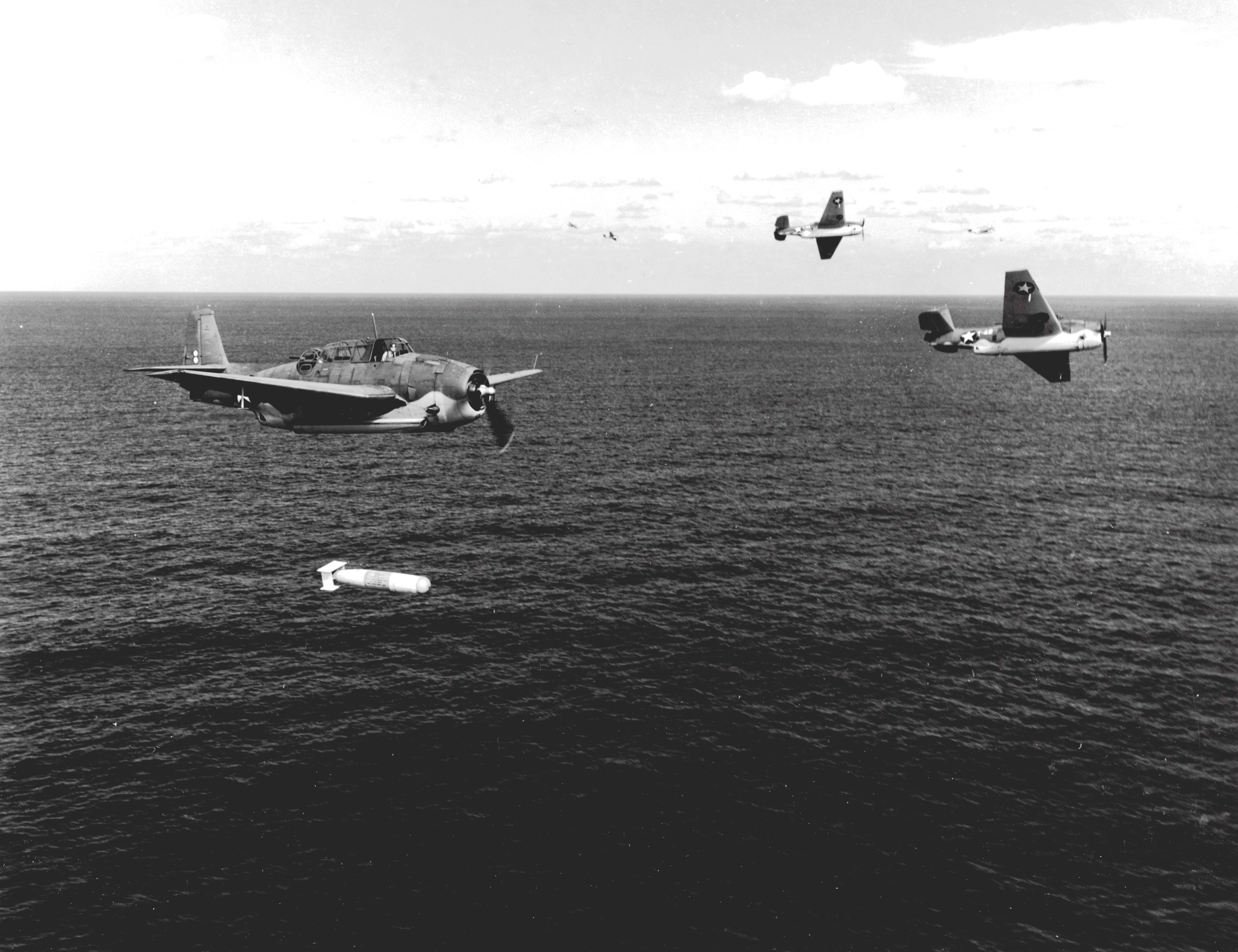 A training flight of TBF-1 Avengers lining up to drop practice torpedoes, late 1942, off the east coast of the United States. Photo 3 of 4.