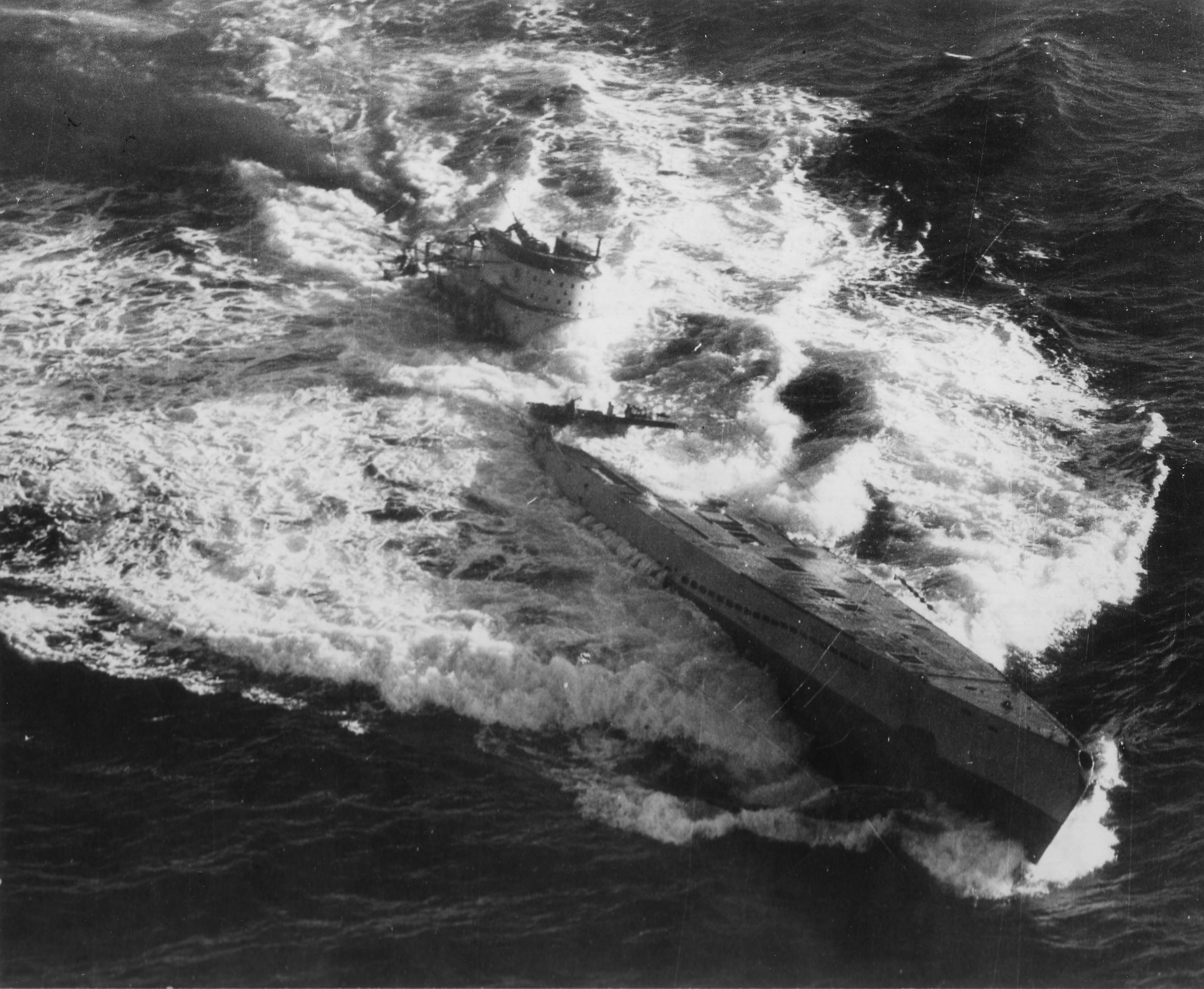 Type IXC/40 U-Boat U-185 foundering in the mid-Atlantic after an aerial depth charge attack by a TBF-1 Avenger from Escort Carrier USS Core, 24 Aug 1943. 36 were rescued while 43 perished.