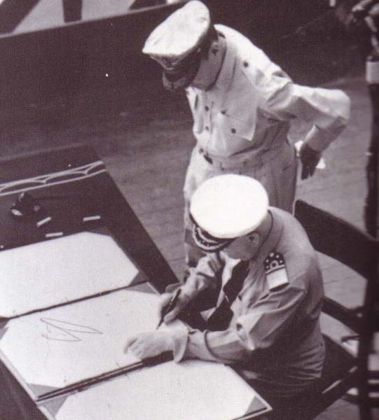Admiral Conrad E. L. Helfrich signing the Japanese surrender document on behalf of the Netherlands aboard USS Missouri, 2 Sep 1945; note MacArthur next to Helfrich. Photo 2 of 2.