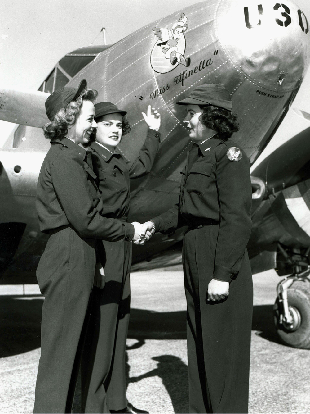 WASP pilots in front of the squadron Beech C-45 Expeditor, “Miss Fifinella,” named in honor of the WASP mascot, 1944, location uncertain but likely Avenger Field, Sweetwater, Texas, United States.