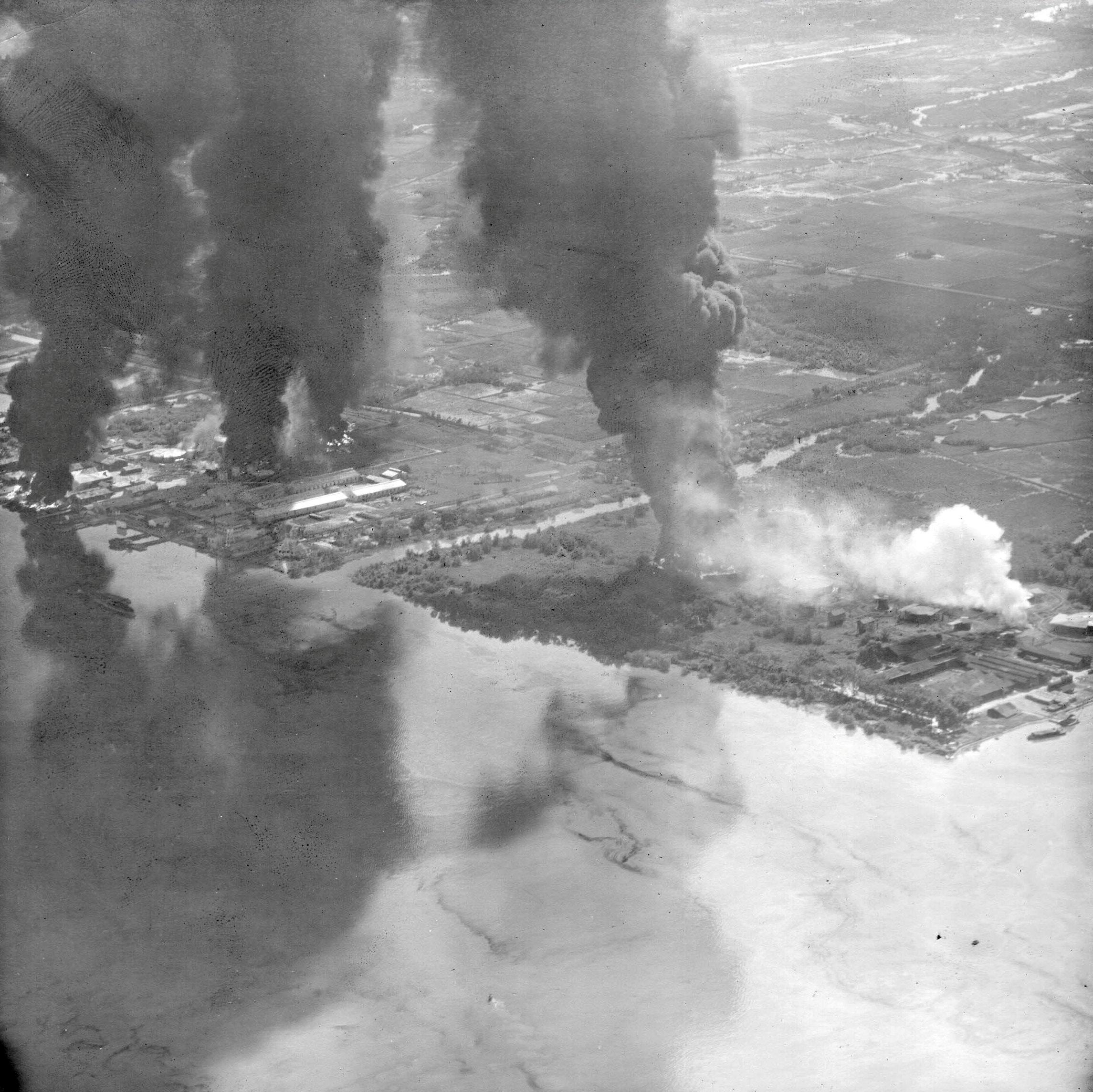 USS Essex strike photo of burning oil storage tanks at Saigon, French Indochina (Ho Chi Minh City, Vietnam), 12 Jan 1945.
