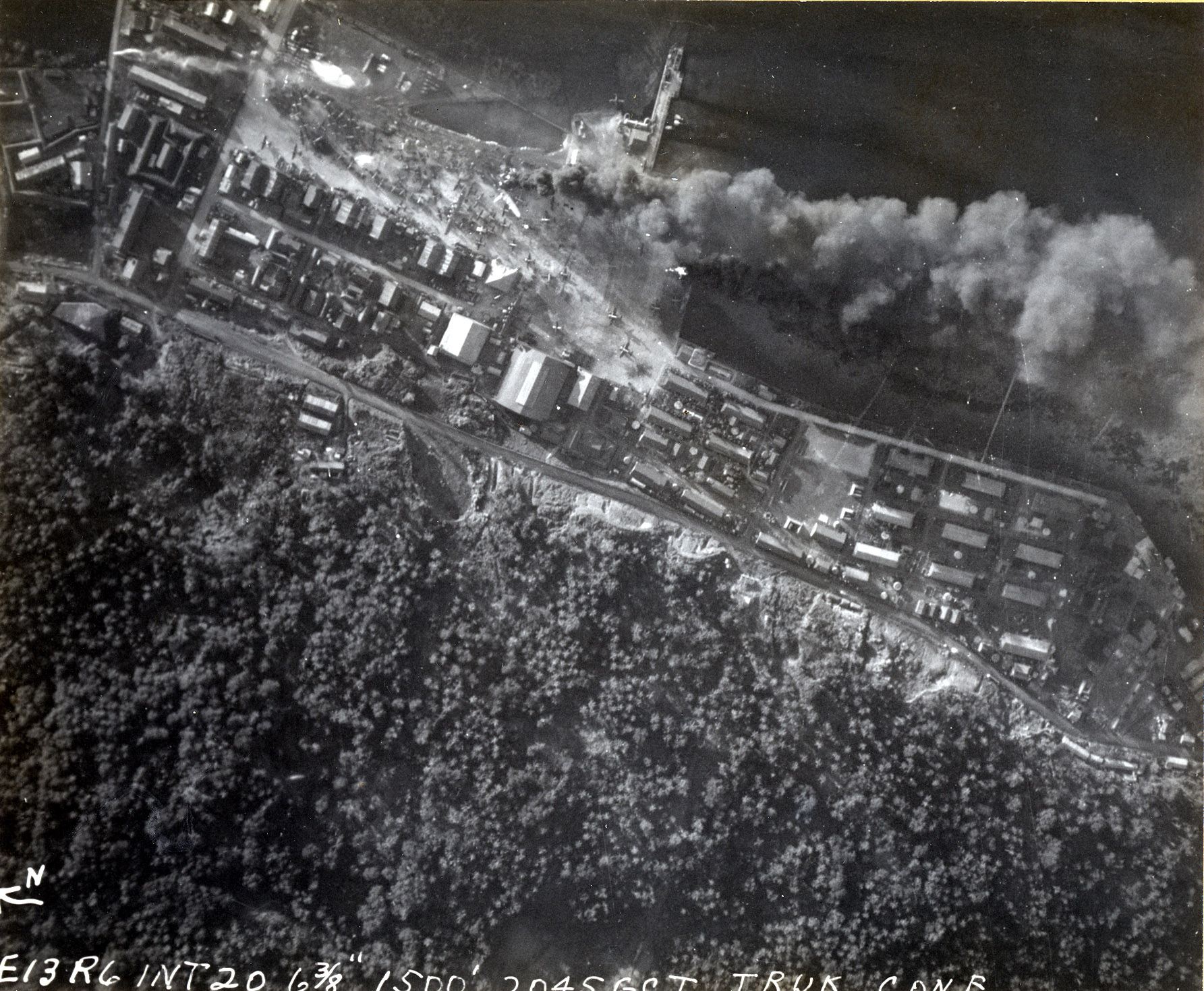 Strike photo taken from USS Intrepid aircraft showing fires at the seaplane base on the south side of Dublon Island inside the Truk Lagoon (now Chuuk), Caroline Islands, 16 Feb 1944. Note burning H6K “Mavis”