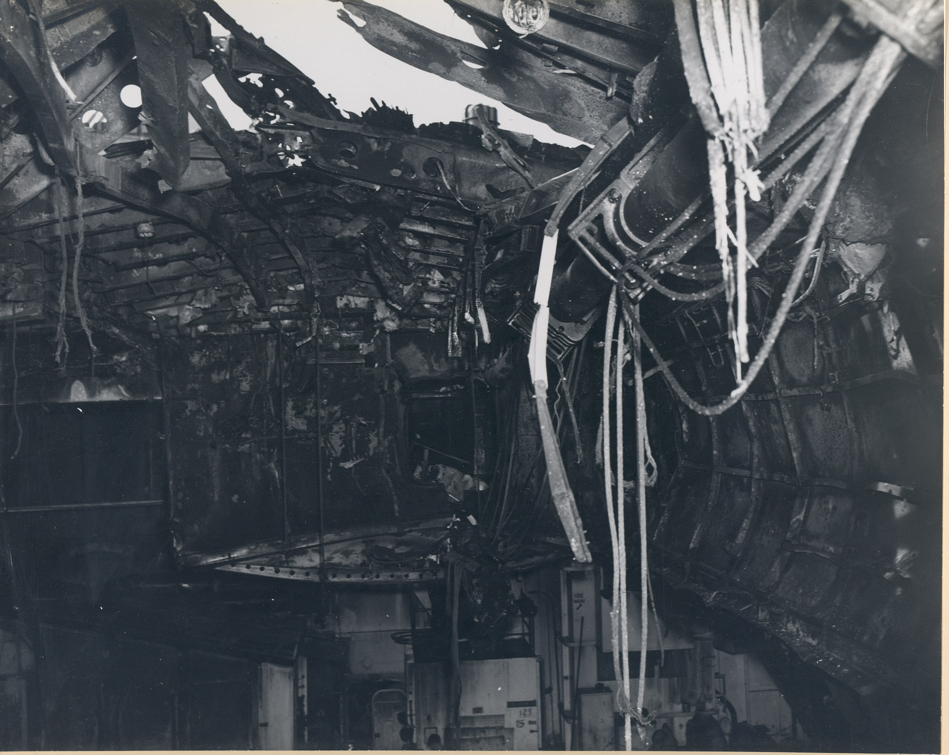 Damage to the flight deck and the hangar deck of USS Intrepid following the crash of a Japanese special attack aircraft off the Philippines, 25 Nov 1944