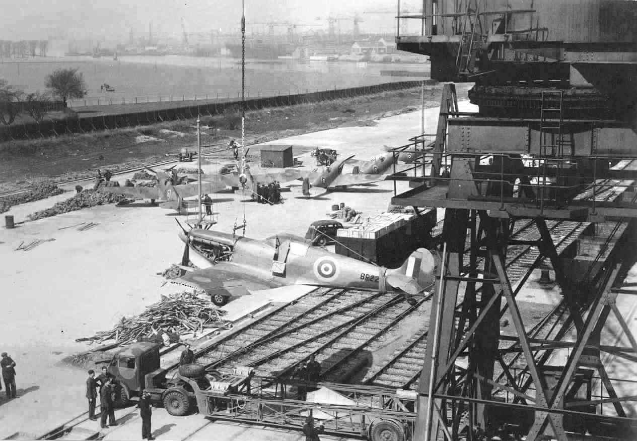 Spitfire Mk. Vc-Tropical variant from No. 603 Squadron RAF being hauled aboard USS Wasp (Wasp-class) by a crane, Glasgow, Scotland, United Kingdom, 13 Apr 1942, photo 1 of 3