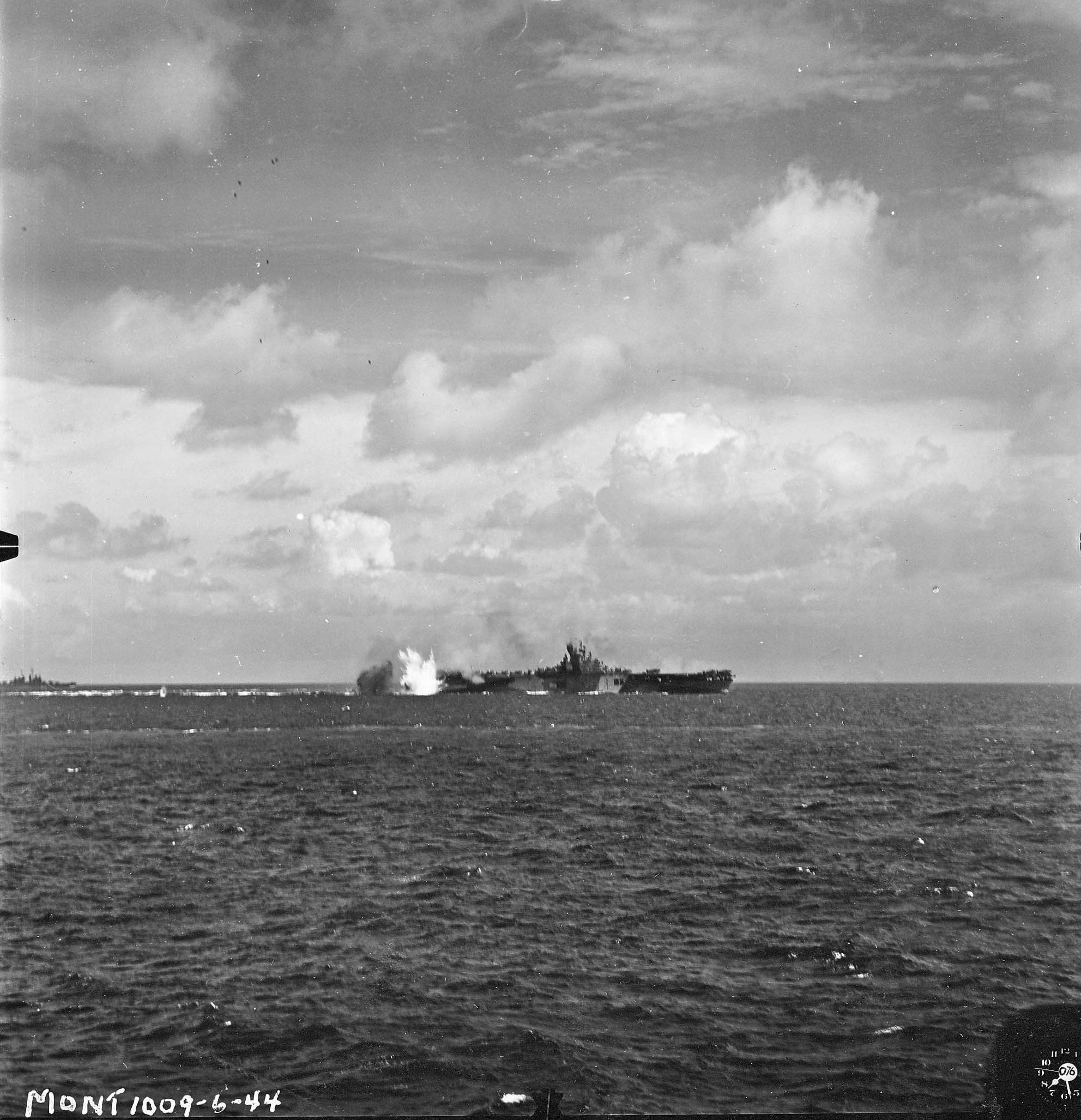 Carrier USS Bunker Hill taking a near miss from a Japanese dive bomber close aboard the starboard quarter, 19 Jun 1944 off Guam, Mariana Islands. The ship was not damaged. Photo 1 of 2