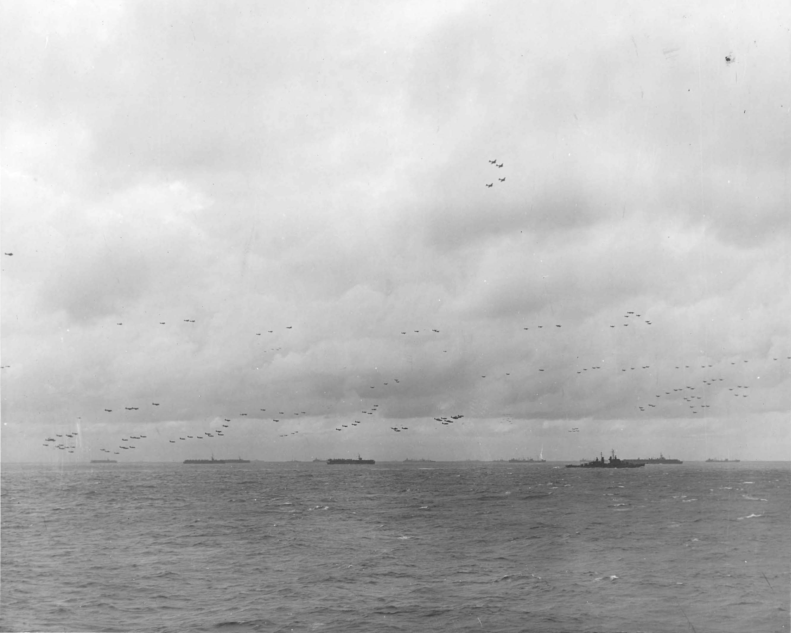 The US Third Fleet steaming in tight formation for a photo opportunity as close to 200 airplanes fly overhead, 22 Aug 1945. Photo taken from USS Wasp (Essex-class). Note five Light Carriers.