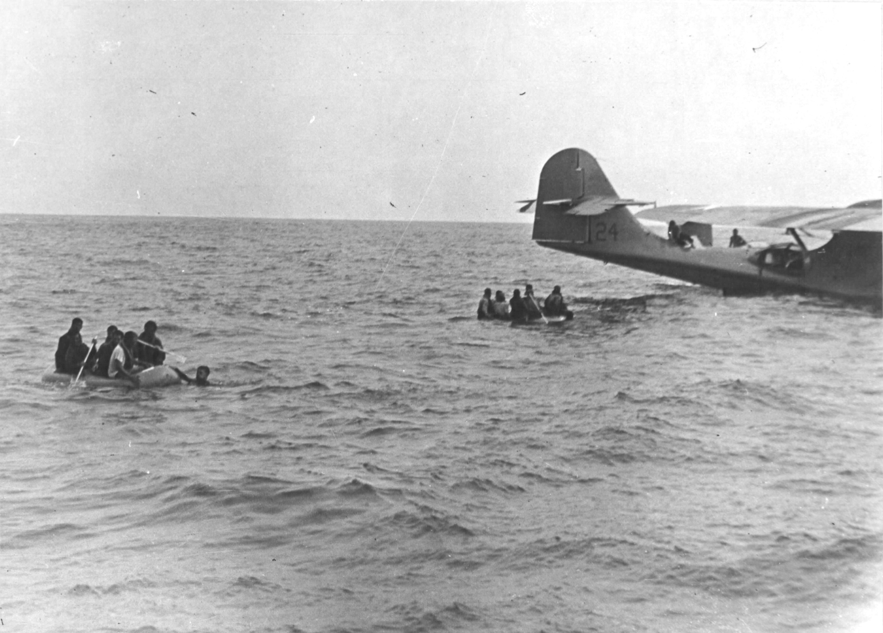 The rescue of Brigadier General Nathan Twining and his party of 14 who had been adrift in the Coral Sea for 5 days after their B-17 aircraft was forced to ditch, 1 Feb 1943. Note PBY Catalina of Patrol Squadron VP-91