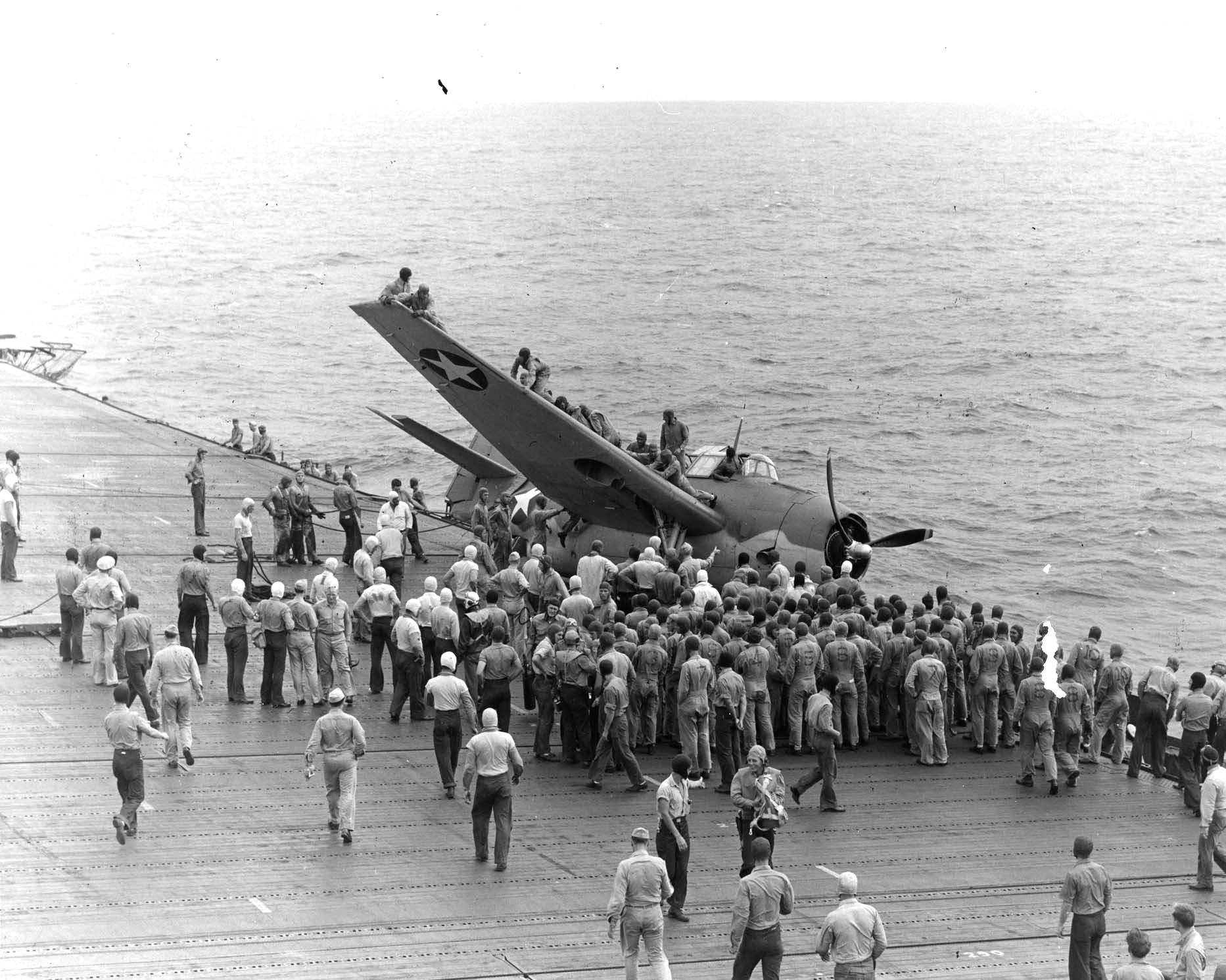 The USS Enterprise conducted flight training when steaming from Hawaii to Tonga on 23 Jul 1942. Here, upon landing, a TBF Avenger slid off the flight deck into the catwalks; no injuries.