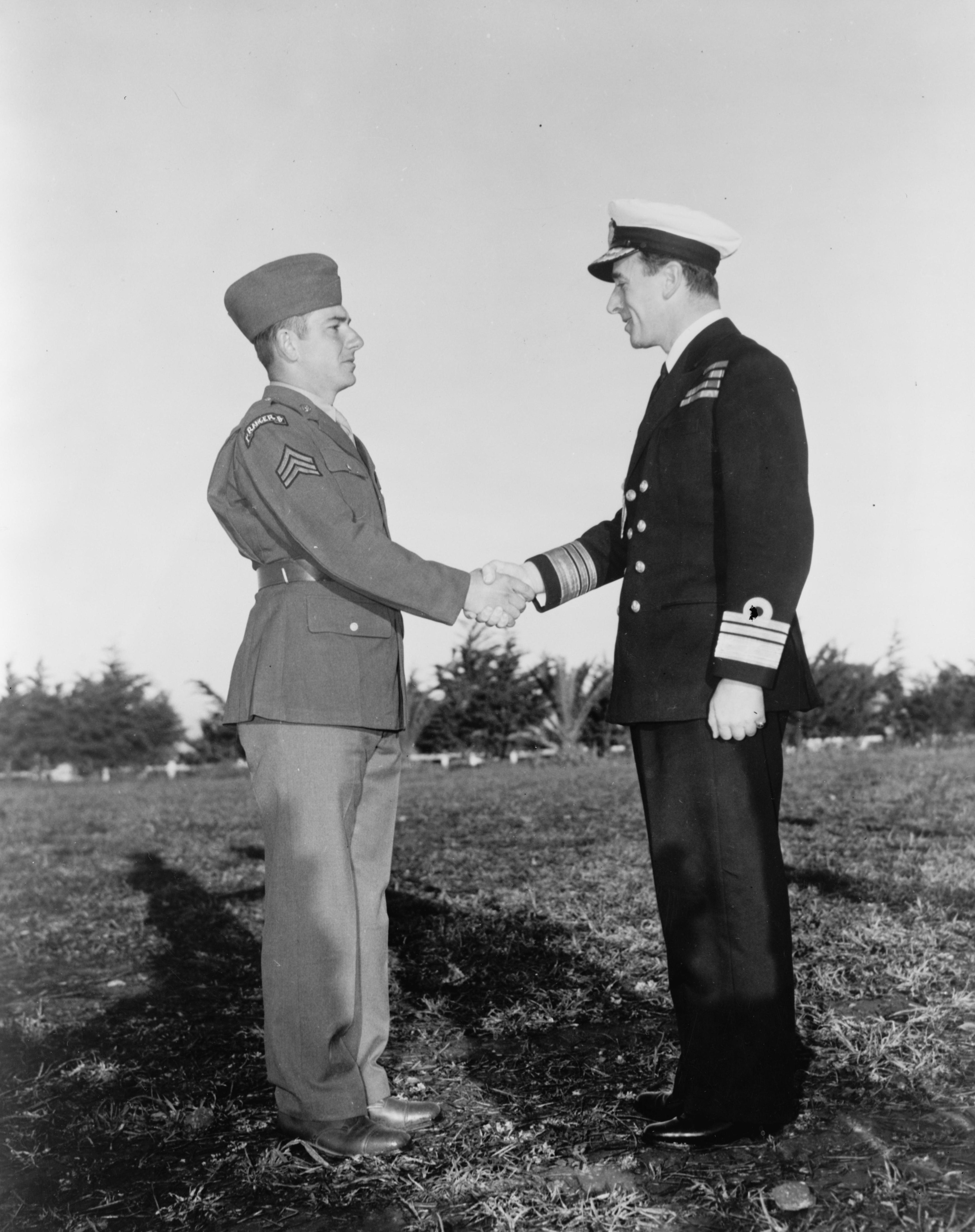 US Army Ranger Sergeant Franklin Koons shaking hands with British Vice Admiral Louis Mountbatten immediately following being presented with Great Britain’s Military Medal at Casablanca, French Morocco, 18 Jan 1943