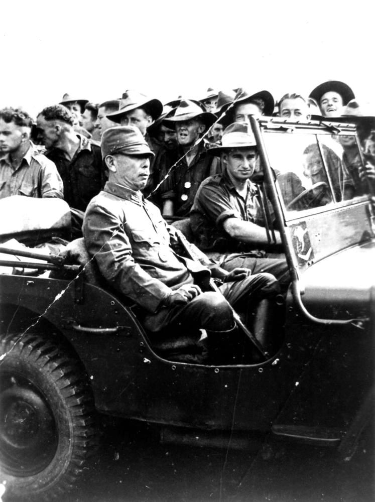 An Australian soldier driving Japanese Lieutenant General Hatazo Adachi to the Wom Airstrip, New Guinea for the formal New Guinea surrender ceremony, 13 Sep 1945