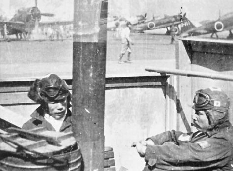 Japanese pilots Warrant Officer Yuzaburo Toguchi and Ensign Matsuo Hagiri at Yokosuka Airfield, Japan, 1945; note N1K Shiden-kai and A6M aircraft