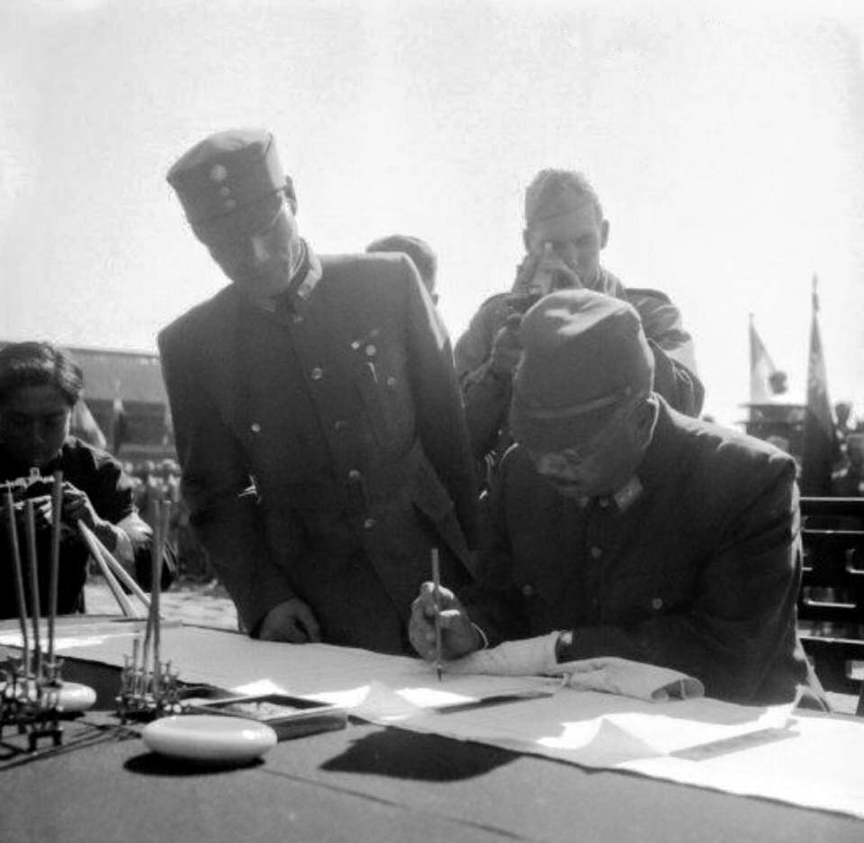 Hiroshi Nemoto signing the surrender document at the Forbidden City, Beiping, China, 10 Oct 1945, photo 2 of 3