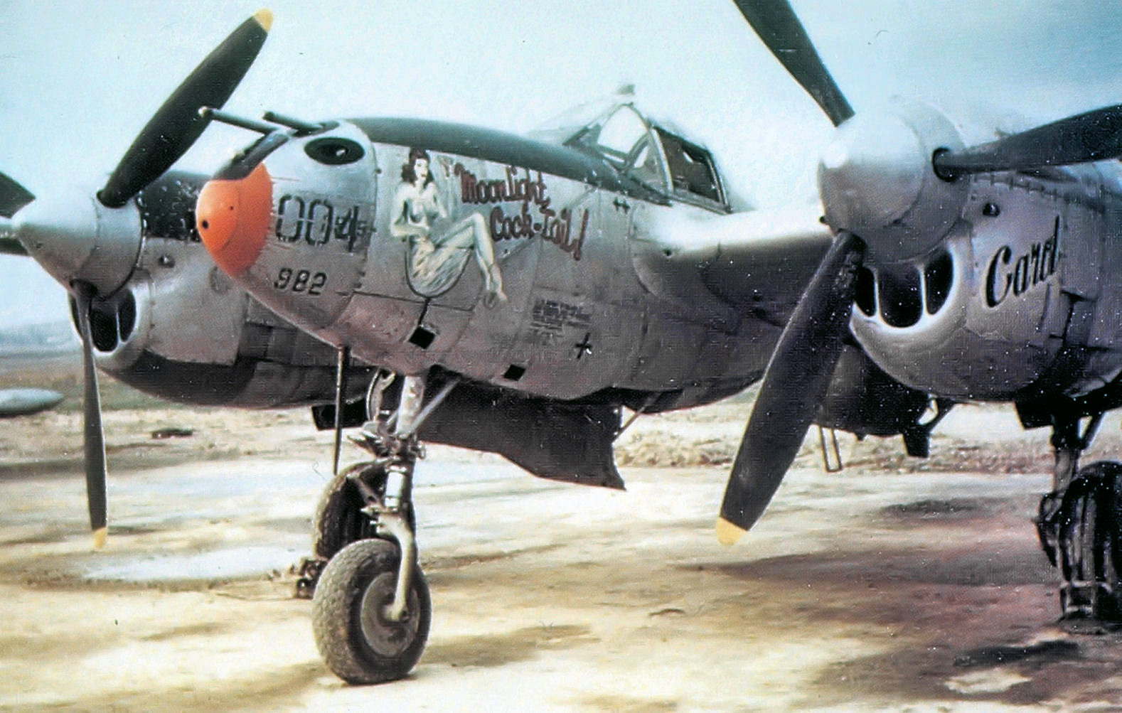 P-38J Lightning ‘Moonlight Cocktail’ of the 392nd Fighter Squadron at Juvincourt Airfield, Aisne, France, Jan 1945. Note ‘Card’ painted on the engine cowl.