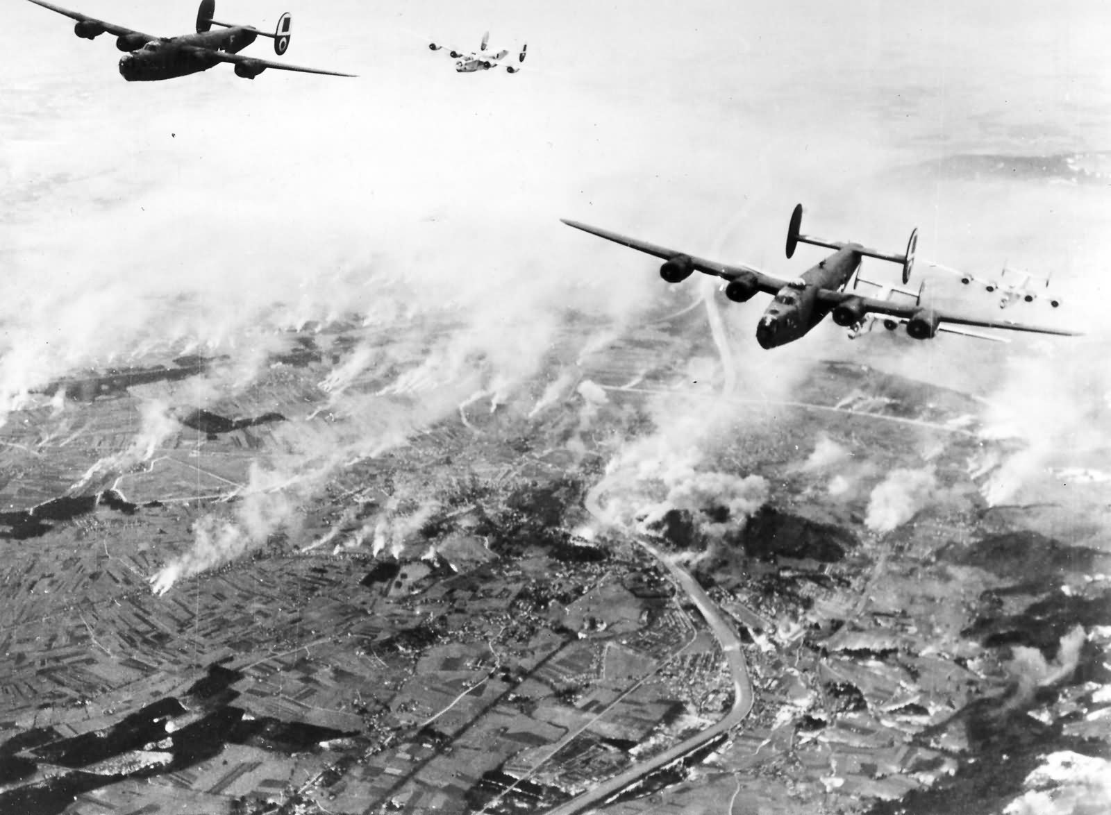 B-24 Liberators of the 460th Bomb Group, 15th Air Force flying from Spinazzola, Italy bombing the railroad yards in Salzburg, Austria, 22 Nov 1944. The smoke is from smudge pots lit to obscure the target.