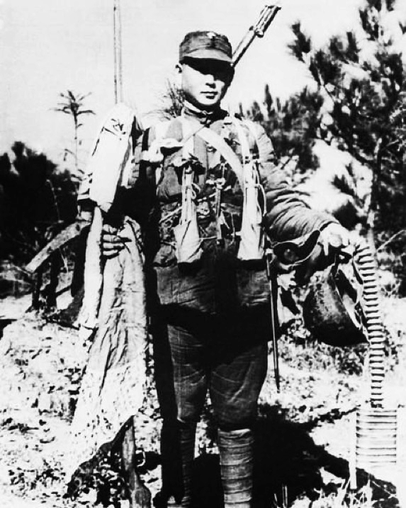 Chinese soldier displaying captured Japanese equipment, Tai'erzhuang, Shandong Province, China, mid-Apr 1938