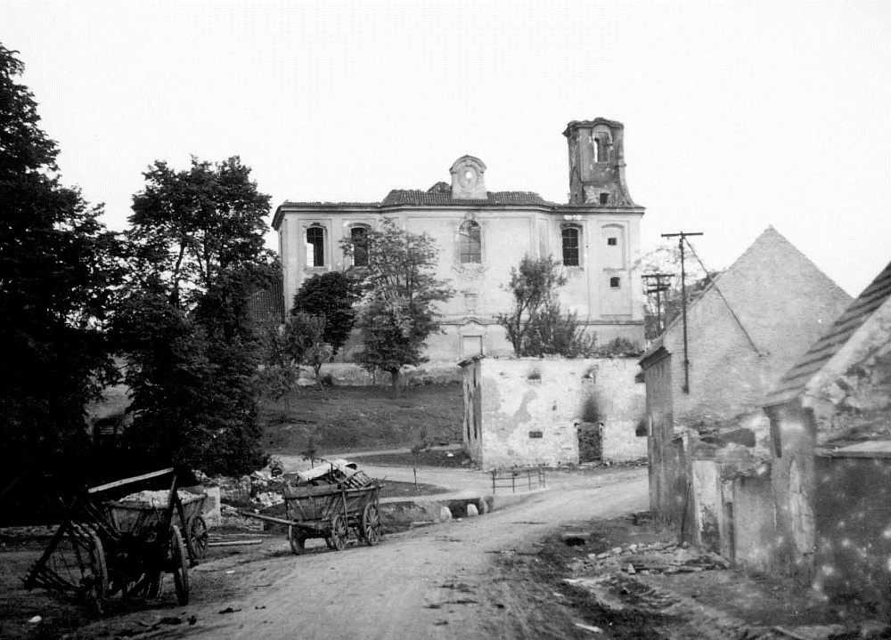 Lidice, Czechoslovakia 10 Jun 1942. St. Martin’s church built in 1732 with one of the village’s barns in the foreground burned out but before explosives reduced them to rubble.
