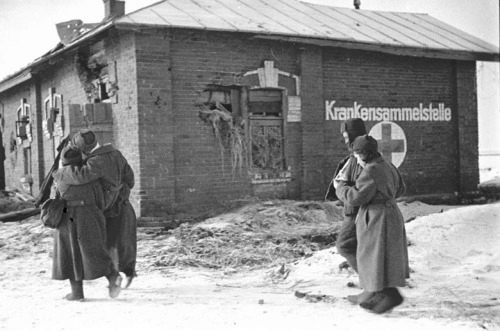 Wounded Soviet soldiers at a field hospital, date unknown; note German markings on wall indicating possible recent capture