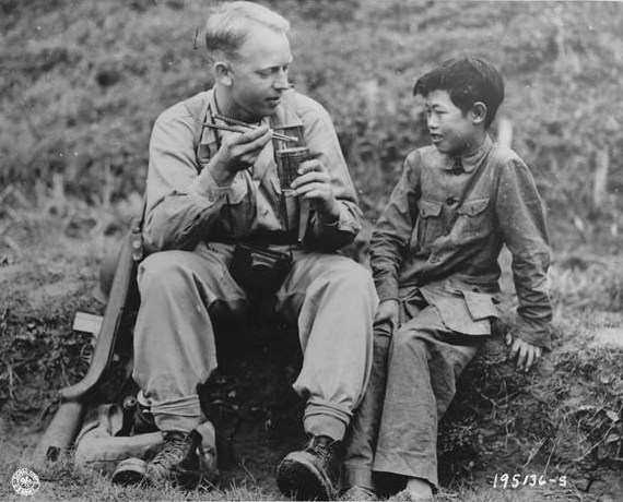 US Army Signal Corps photographer Private Arthur W. Hedgo with Chinese boy Lee Ting Yow, northern Burma, 6 May 1944