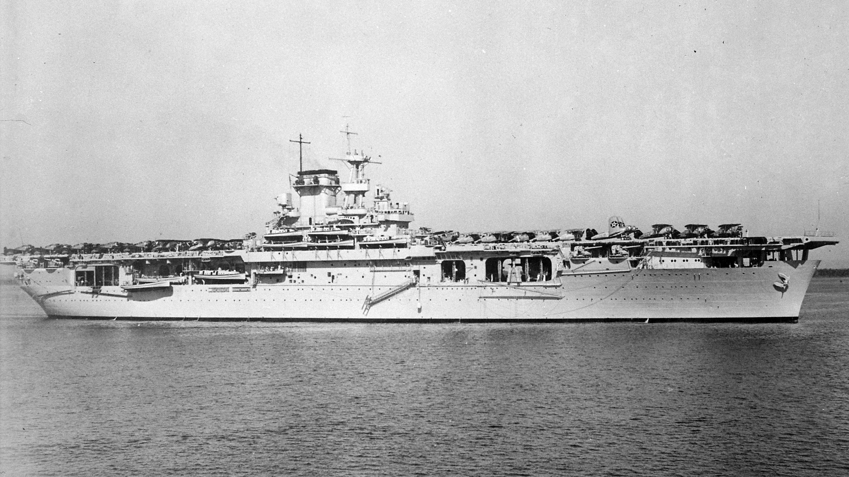 Broadside view of USS Wasp (Wasp-class) at anchor on 27 Dec 1940, probably in Guantanamo Bay, Cuba. Note F3F fighters and SB2U Vindicator aircraft on the flight deck.
