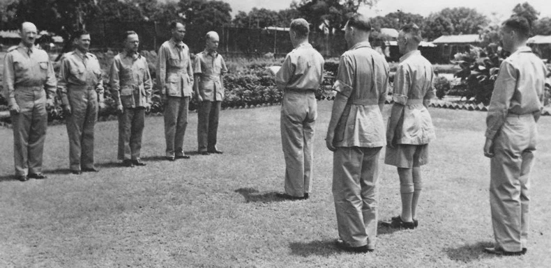 Colonel William E. Bergen reading medal citations while Lieutenant General Joseph Stilwell and Major General F. C. Sibert looked on, India, mid-1942