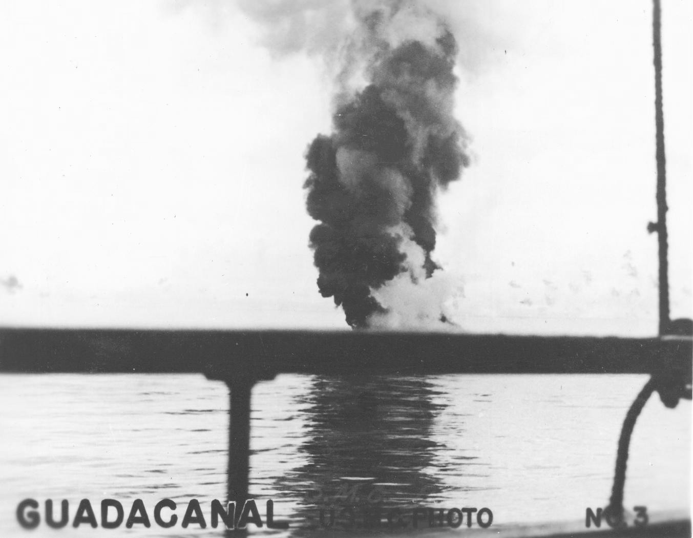 Smoke rising from a crashed Japanese aircraft, off Guadalcanal, late 1942; photo taken from transport Crescent City