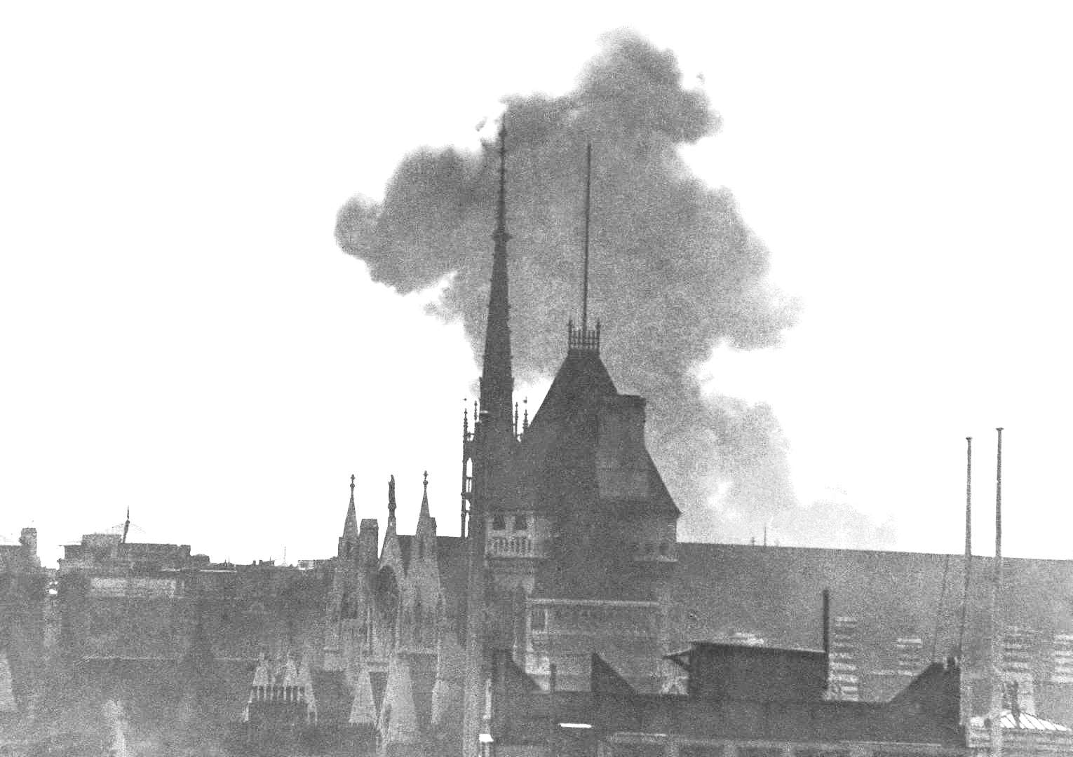 As seen from the Fleet Street rooftops, a V-1 Flying Bomb strikes near Kings Way or Drury Lane with the Law Courts towers in the foreground, London, England, United Kingdom, 3 Aug 1944. Photo 2 of 2.
