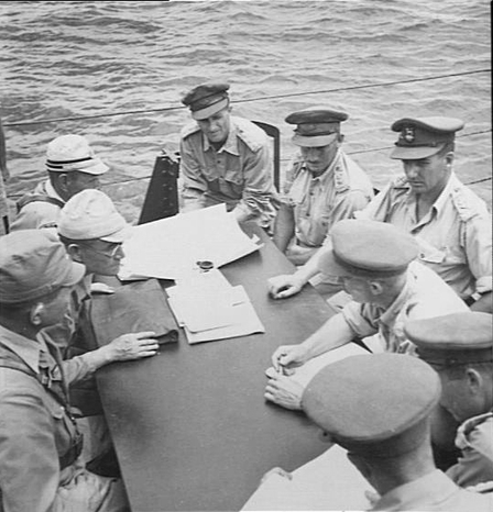 Vice Admiral Michiaki Kamada (far left) surrendering Japanese Naval forces on Borneo to Australian Major General Edward Milford aboard HMAS Burdekon in Makassar Strait, 8 Sep 1945.