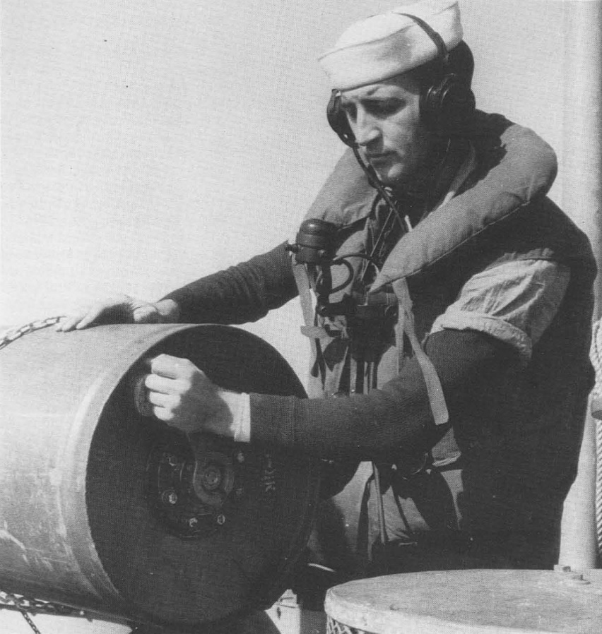 United States Coast Guard sailor setting the depth fuse on a depth charge aboard sub-Chaser PC-556 in the Atlantic, 8 Oct 1942