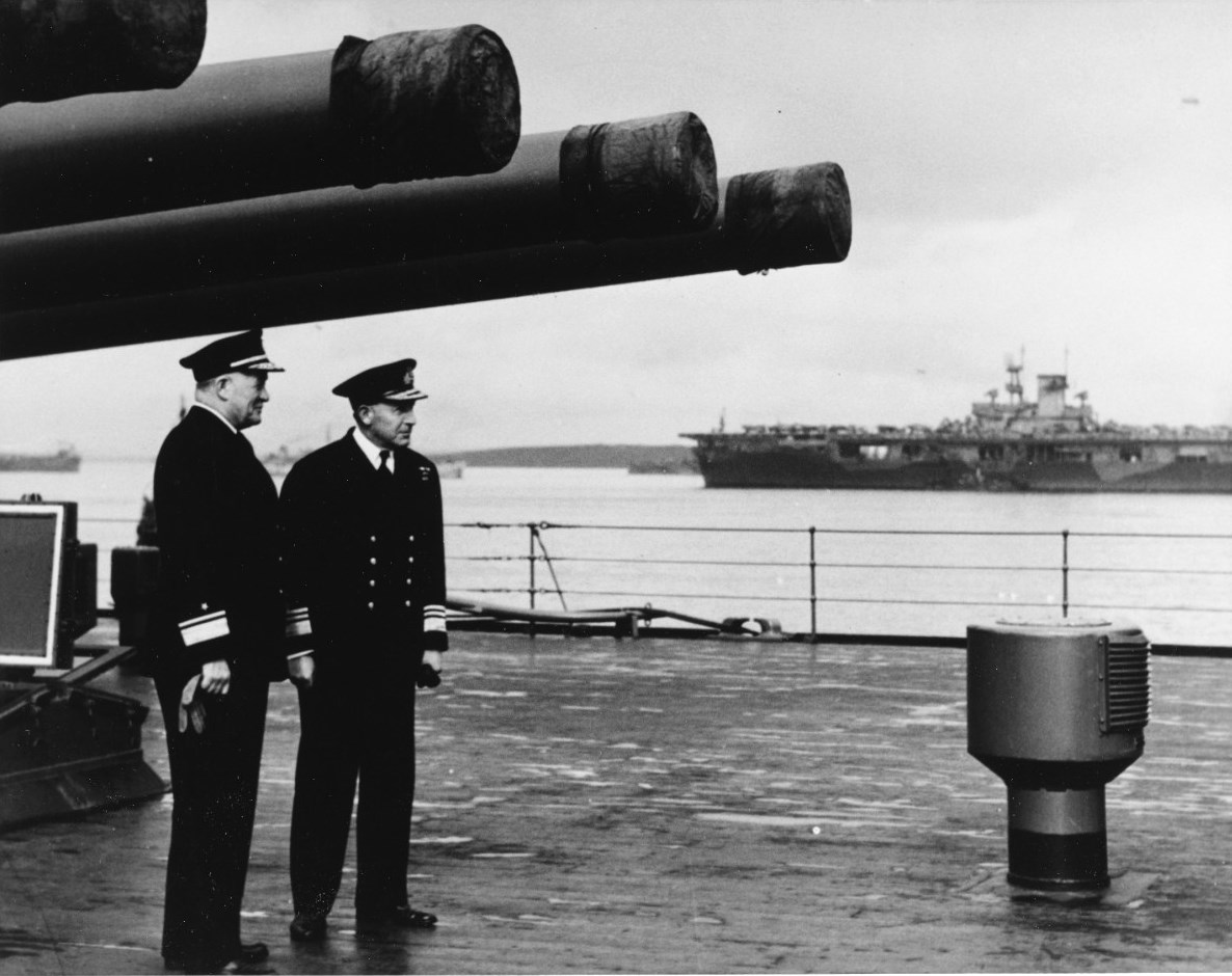 United States Navy Rear Admiral Robert Giffen (left) and Royal Navy Vice-Admiral Alban Curteis aboard HMS Duke of York at Scapa Flow, Scotland, United Kingdom, 5 Apr 1942. Note carrier USS Wasp (Wasp-class).