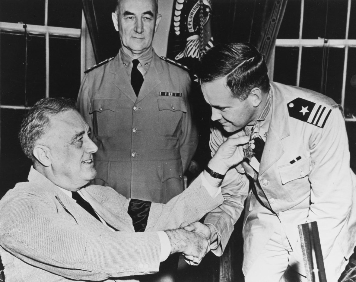 US Navy Lt Commander John D. Bulkeley receives the Medal of Honor from President Franklin Roosevelt, 4 Aug 1942. The medal was for his actions as a PT Boat Squadron commander in the Philippines, Dec 1941-Apr 1942