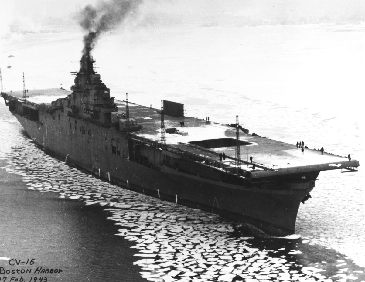 On the day of her commissioning, USS Lexington (Essex-class) makes slow headway through the icy waters of Boston harbor, Boston, Massachusetts, United States, 17 Feb 1943.