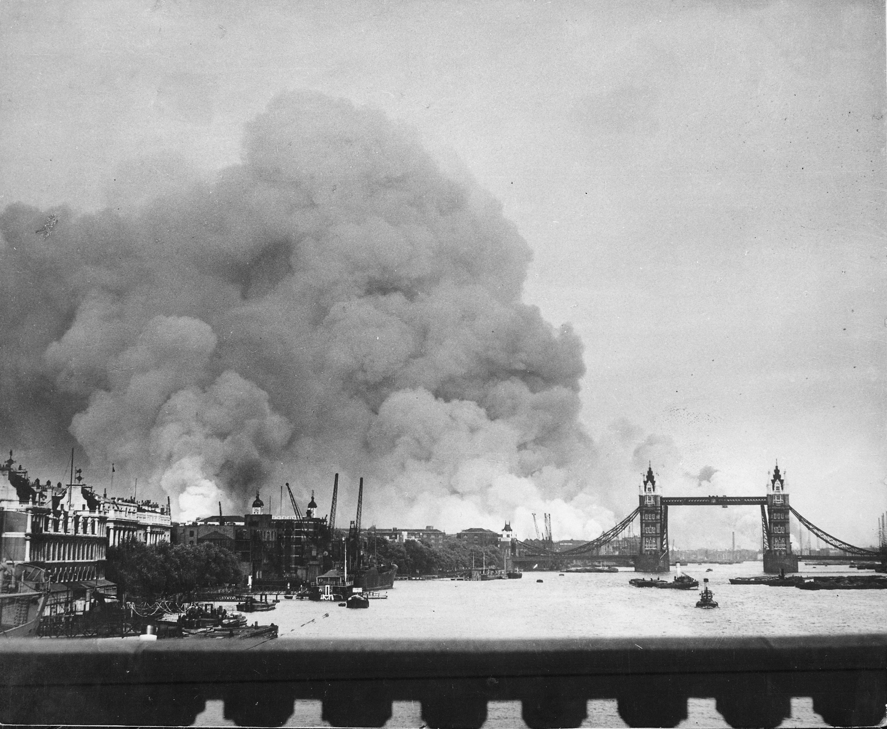 Smoke rising from the Surrey Docks, London, England, United Kingdom, 8 Sep 1940, the morning after the opening night of “The Blitz” bombings as seen from London Bridge. Note Tower Bridge silhouetted against the smoke.