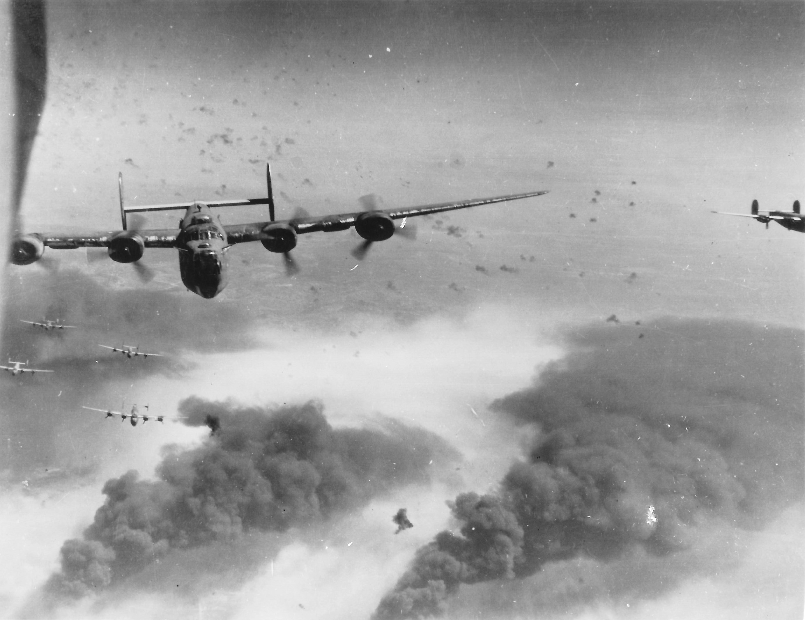 B-24 Liberator bombers of the 451st Bomb Group flying from Italy over Ploesti oil fields, Romania, May-Aug 1944. Photo 2 of 2.