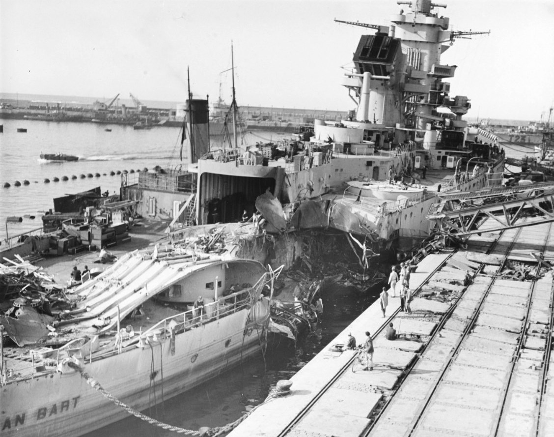 The incomplete French battleship Jean Bart at Casablanca, French Morocco, 16 Nov 1942, with damage from 16-inch shells and 1,000-pound bombs inflicted by US Navy forces on 8 Nov 1942 during the Operation Torch landings.