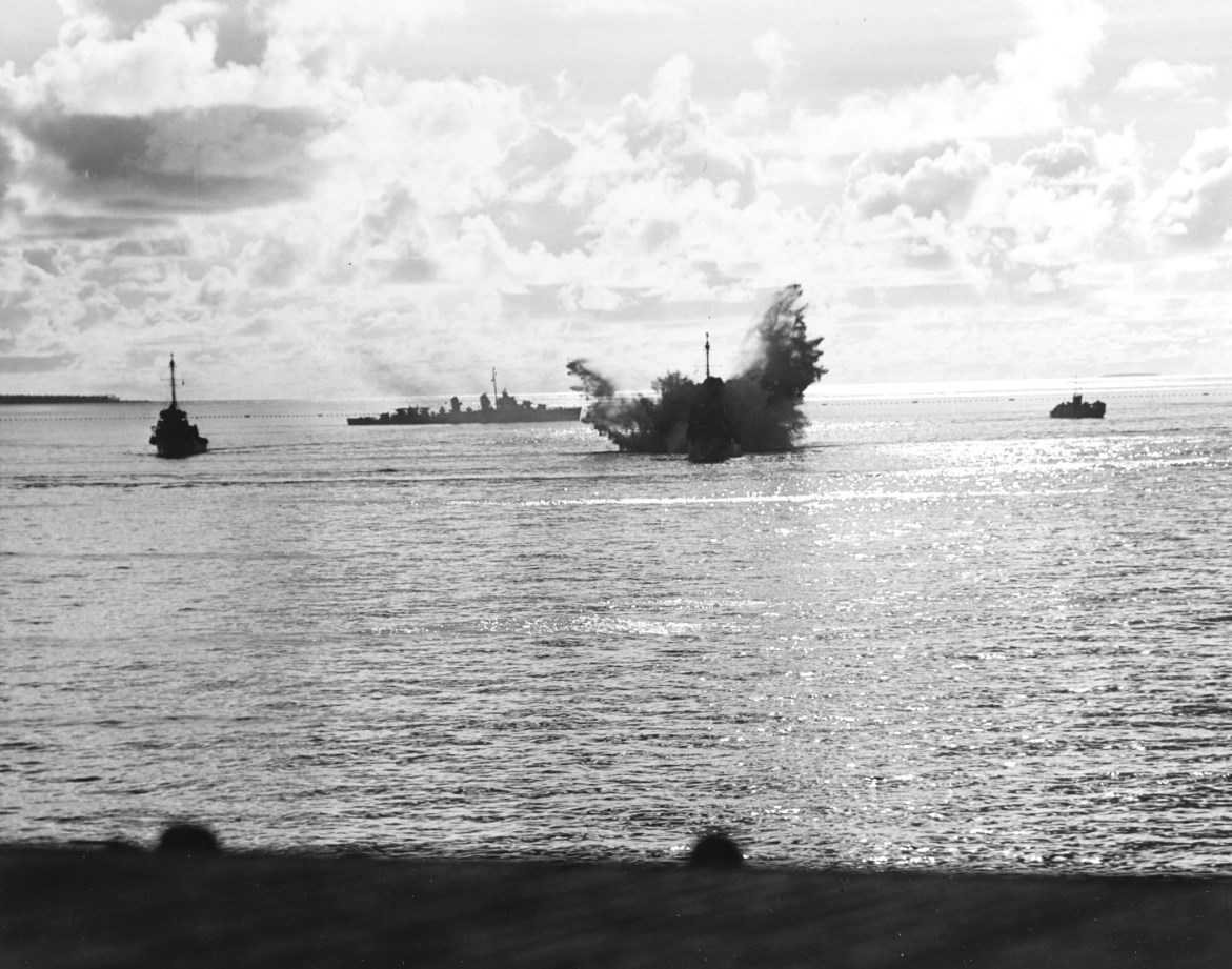 A destroyer escort dropping depth charges on a second Japanese Kaiten in the cruiser anchorage of Ulithi Lagoon on 20 Nov 1944 after the sinking of USS Mississinewa. Seen from USS Bunker Hill. Photo 3 of 3.