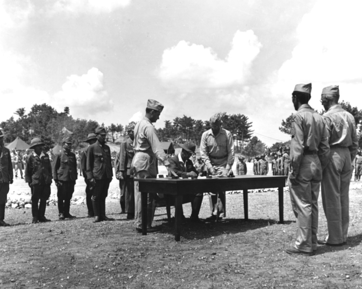Lt General Toshiro Nomi signing the formal surrender all Japanese forces in the Ryukyu Islands to US Lt General Joseph Stillwell at US 10th Army headquarters, Yontan, Okinawa, Japan, 7 Sep 1945