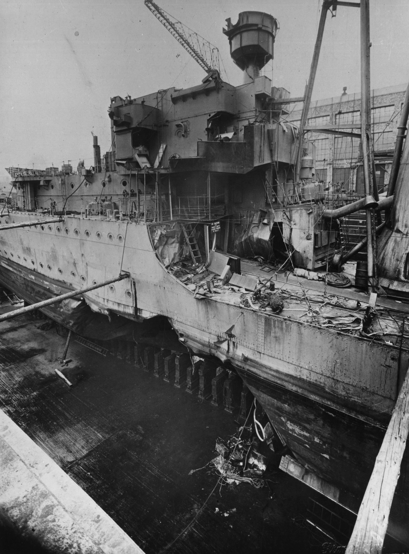 Damaged HMS Kelly in drydock at the Hawthorn Leslie yard, Hebburn, England, United Kingdom, mid-1940