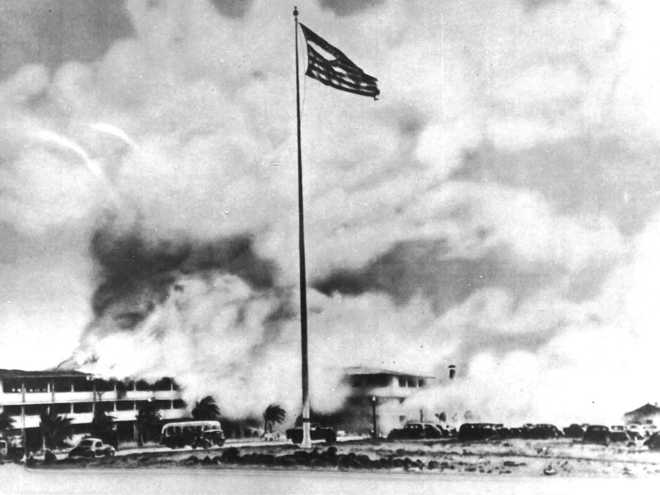 The American flag, battered and torn, flying at the Hickam Field barracks during the Pearl Harbor attack, Hawaii, 7 Dec 1941. This was one of the most published wartime flag photos until Joe Rosenthal’s Iwo Jima photo.